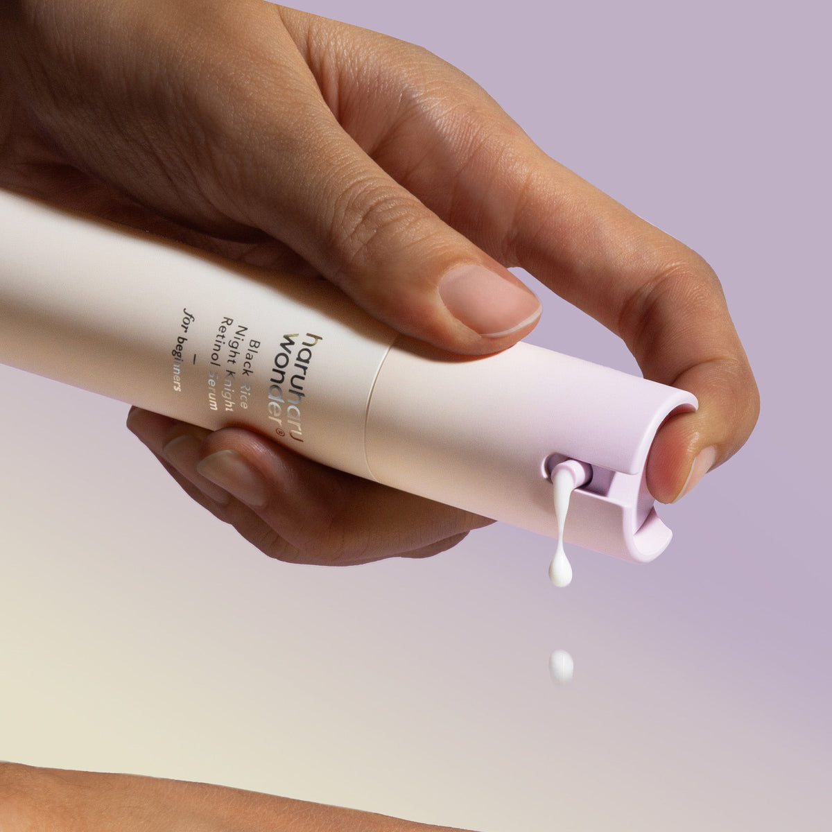Hand drukt de pomp van het Haruharu Night Knight Retinol Serum in
